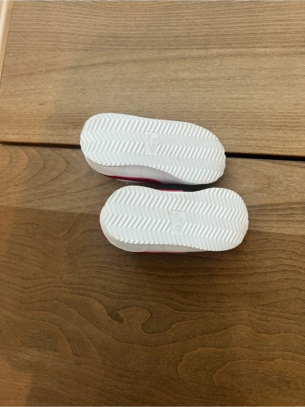 Nike Kids White Sneakers with Red Swoosh and Blue Sole Accent
